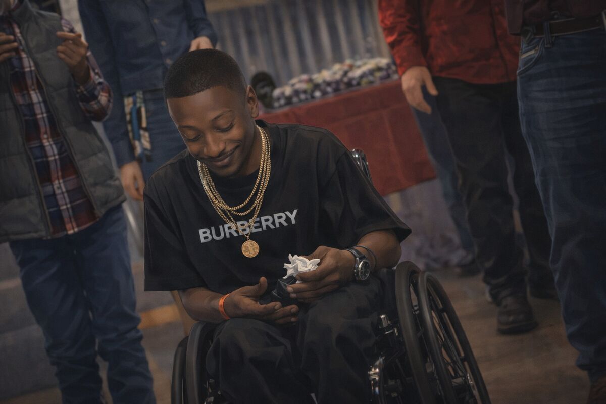 At an event, looking down, smiling